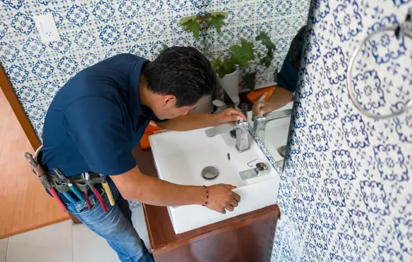 a man fixing a sink