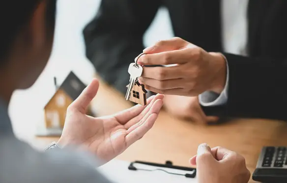 a person handing a key to another person