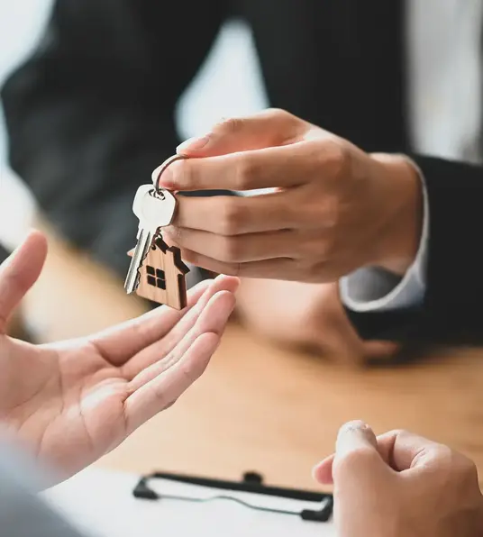 a person handing a key to another person